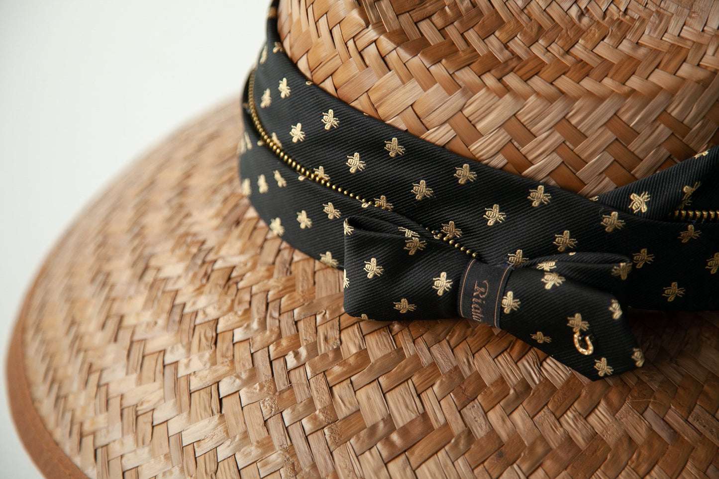 Close-up of bee patterned band and bow