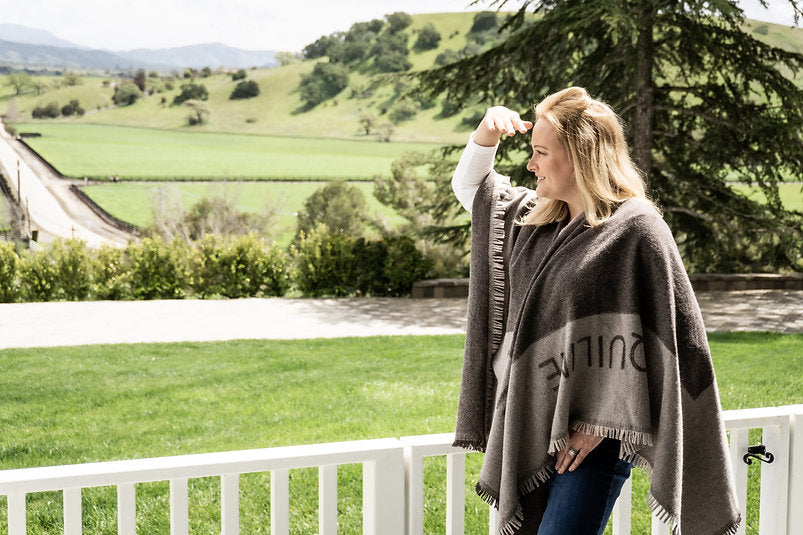 Model in grey poncho