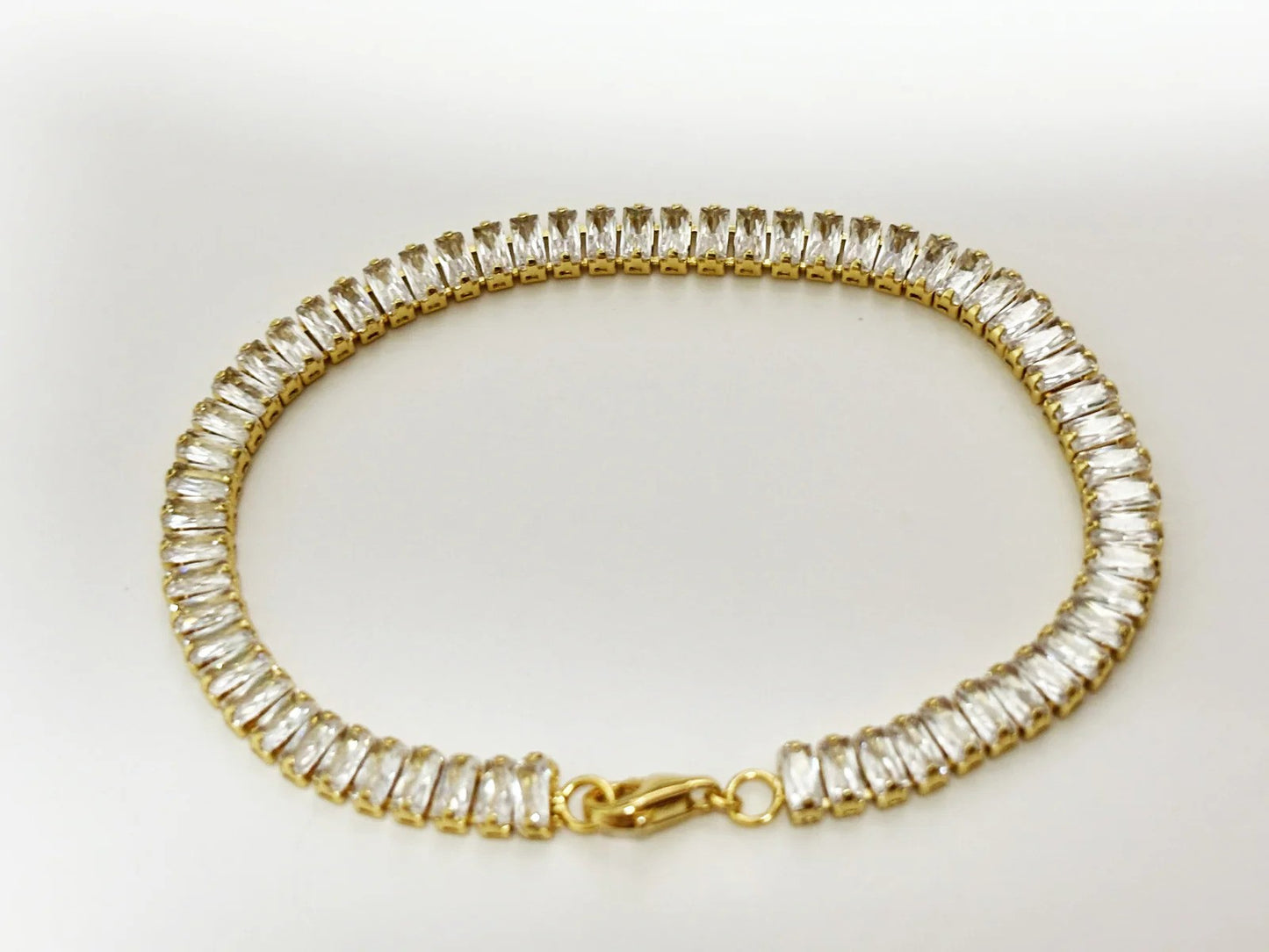 Close up of cubic zirconia and gold-plated bracelet