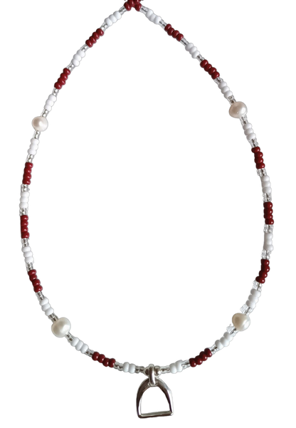 Necklace with red, clear and white beads and stirrup charm