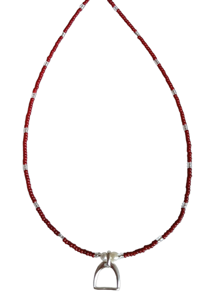 Necklace with red, silver and white beads and stirrup charm