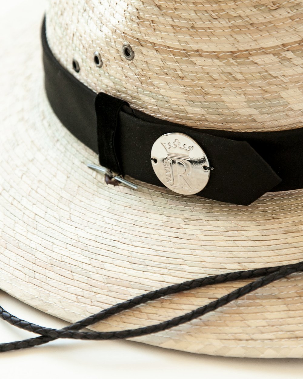 Close-up of hat band and logo medallion