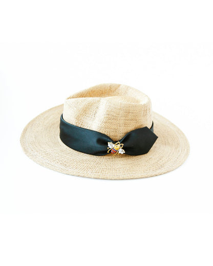 Woven hat with black silk band and bee decoration