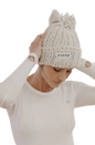 Model wearing cream beanie