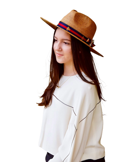 Model wearing hat with blue and red ribbon