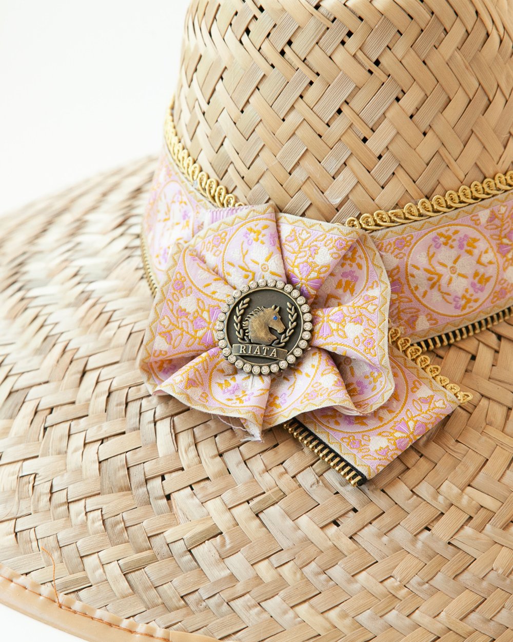 Close-up of Rose Quartz rosette with logo medallion