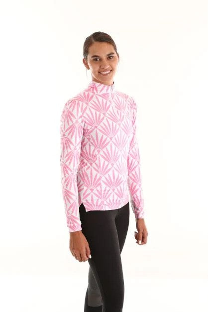 Model wearing white sun shirt with pink palm leaf pattern