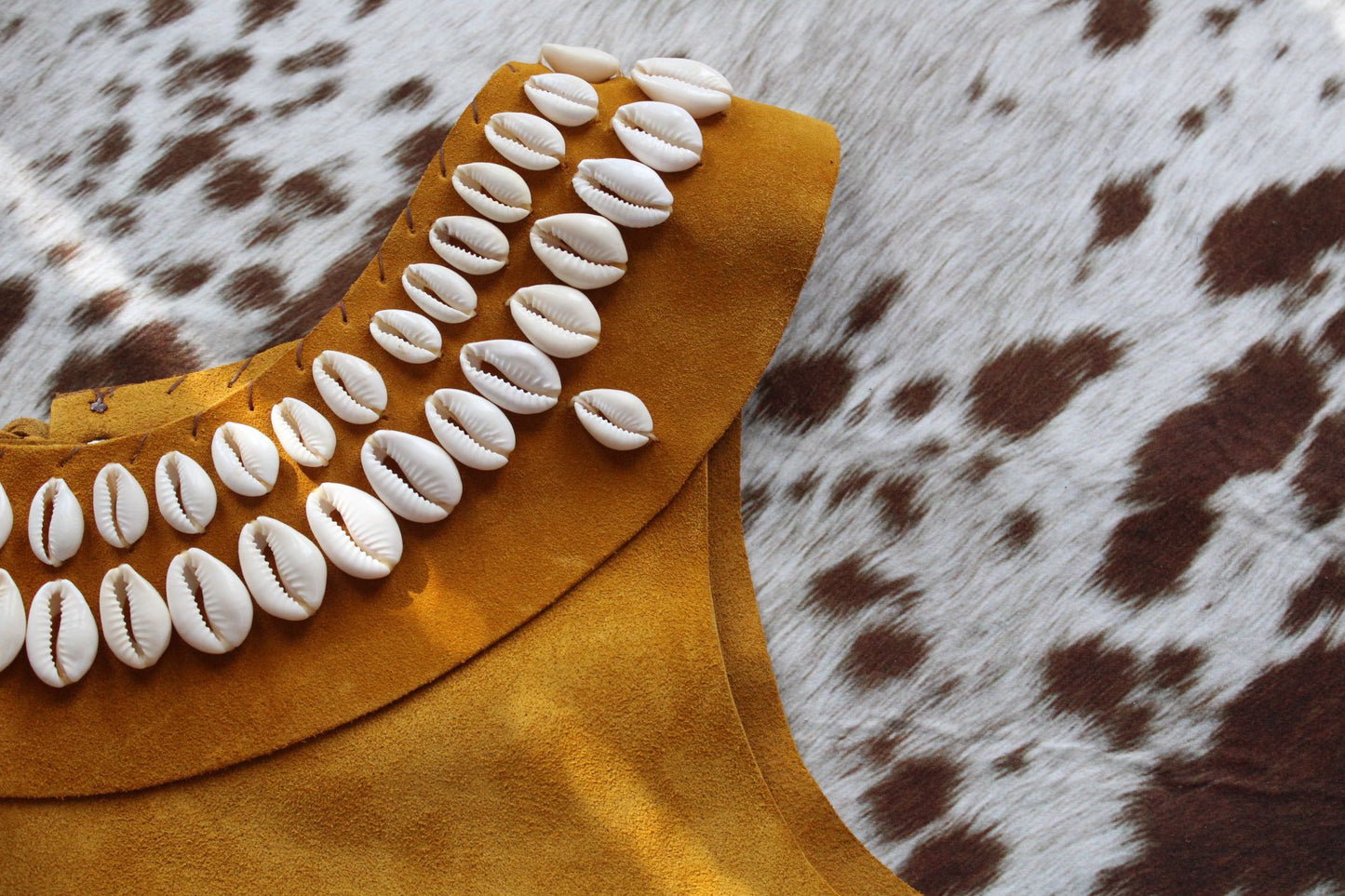 Close up of yellow leather and shell top