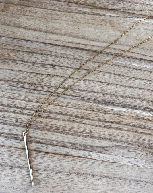 Gold necklace with needle pendant