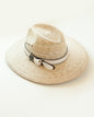 Woven hat with whirte leather band, feather and logo medallion