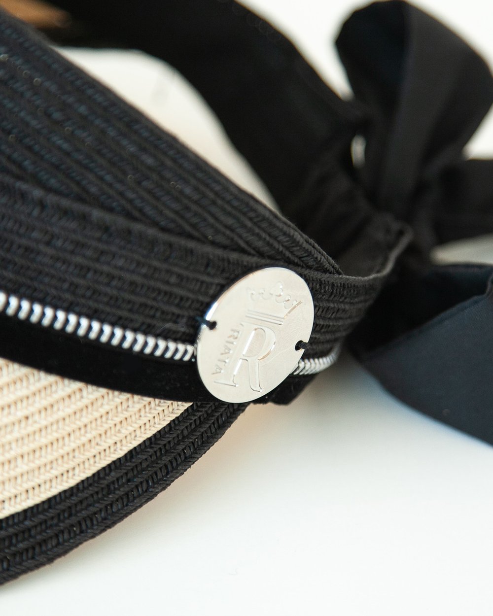 Close-up of visor with black velvet and logo medallion